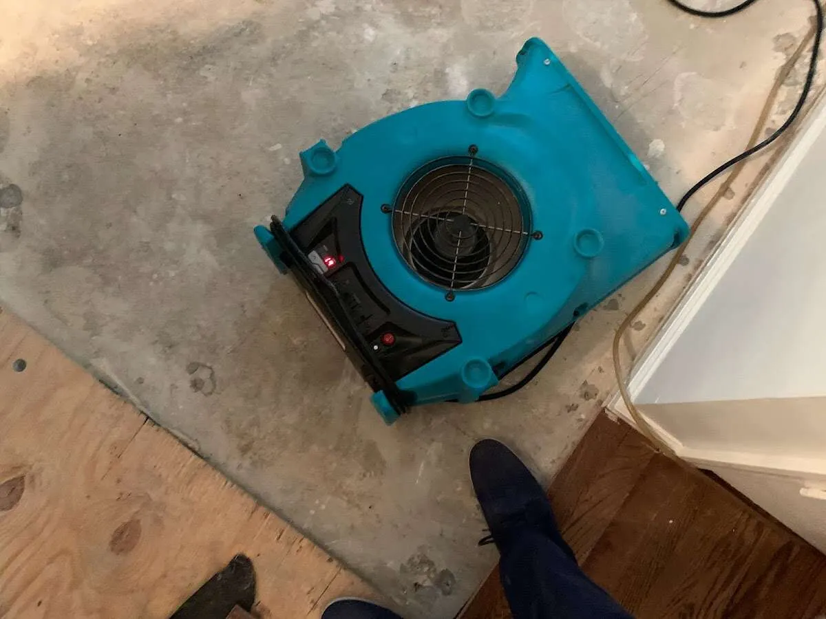 Air mover drying subfloor during Commercial Water Damage Restoration in Lackland AFB